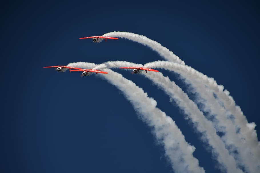 four red planes with contrails, four bi-planes flying up in the sky performing airshow HD wallpaper