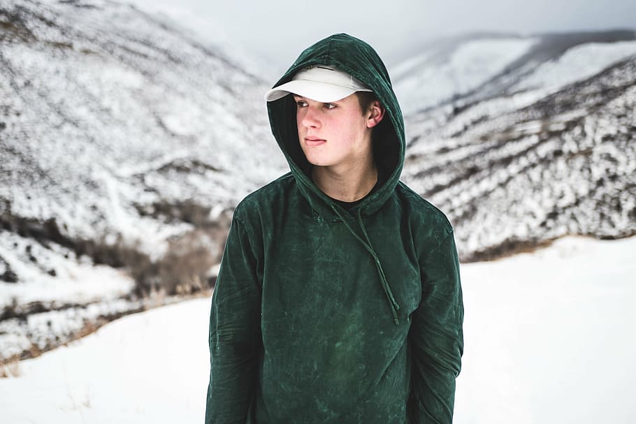 man in green hooded jacket walking on snow coated ground, people HD wallpaper