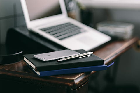 Elegant workspace with Macbook, iPhone, business cards and notebooks HD wallpaper