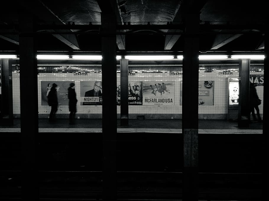 silhouette of persons walking along train statiobn, people, waiting