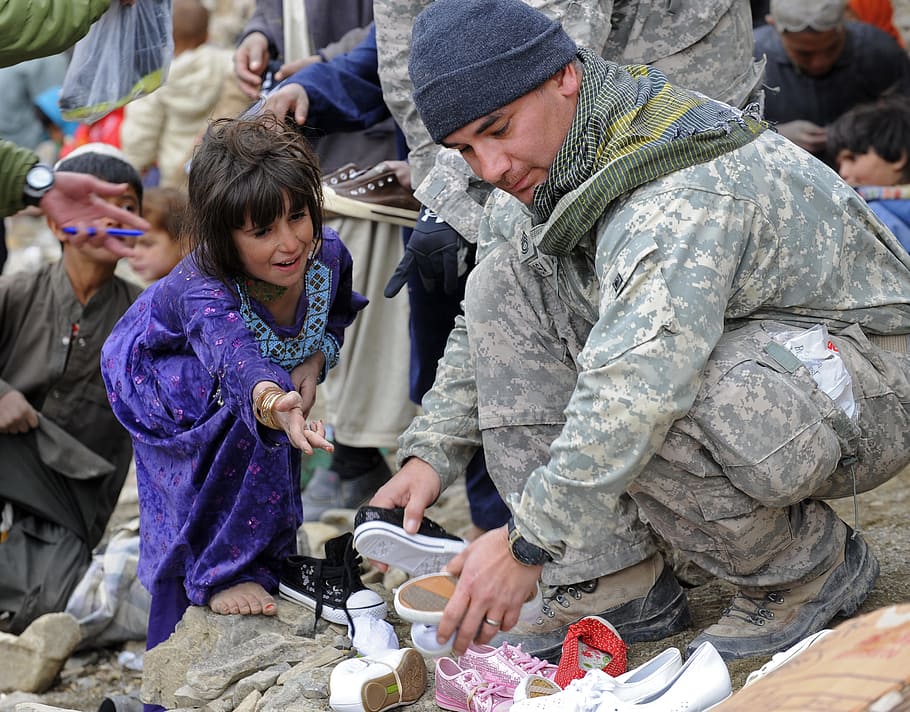 military man holding pair of shoes, soldier, help, child, gift HD wallpaper