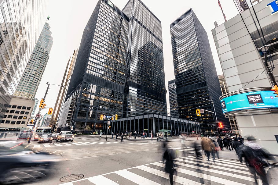 people crossing on pedestrian lane in front high-rise buildings, view of black buildings HD wallpaper