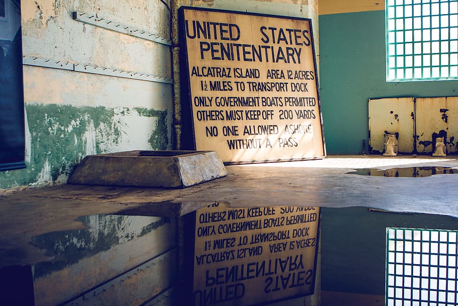 United States Penitentiary near window, brown wooden board with text in building
