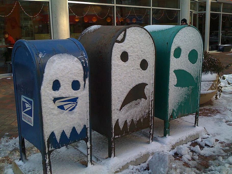 three assorted-color mailboxes with snow face arts during daytime HD wallpaper