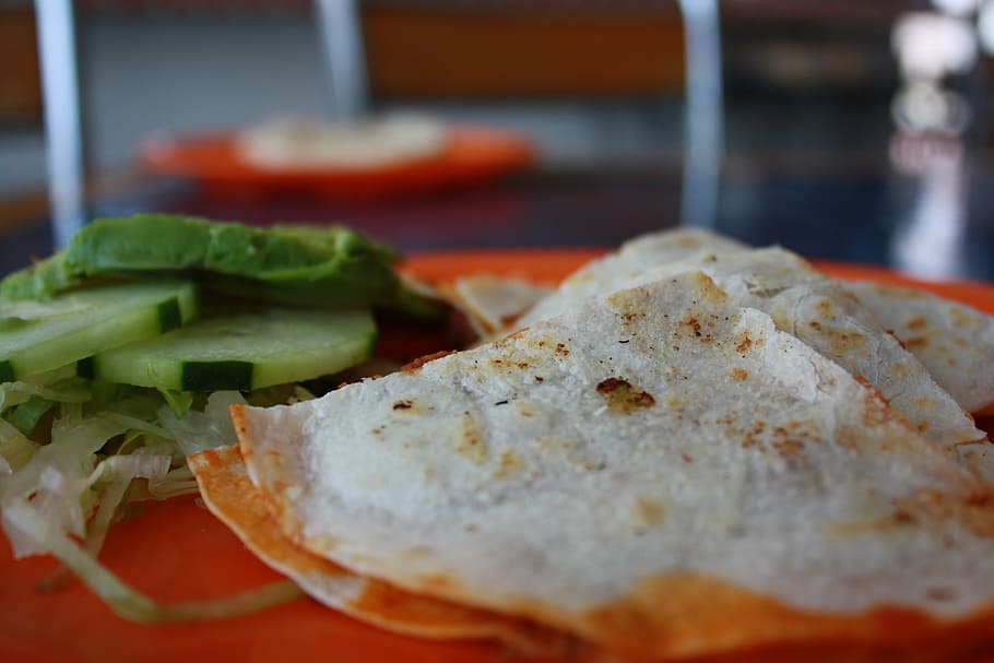 selective focus photography of flat bread and cucumbers, taco