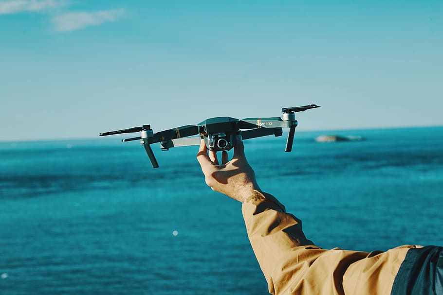 Atlantic flight, person holding black camera drone, sea, ocean HD wallpaper
