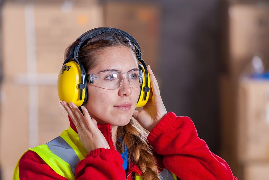 woman wearing yellow headphones, industrial, security, logistic