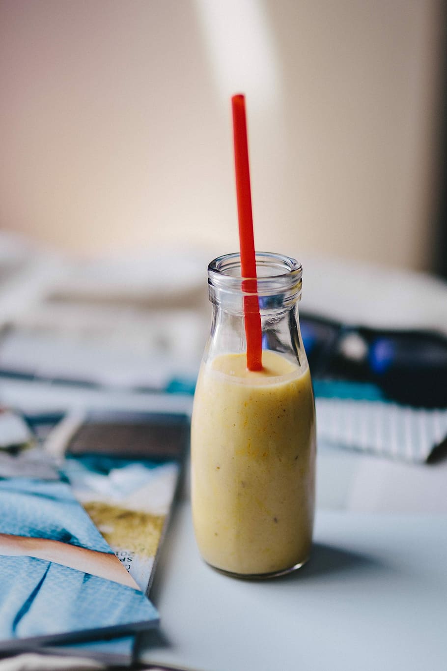 Healthy shake in a small bottle with a straw and sunglasses, drink