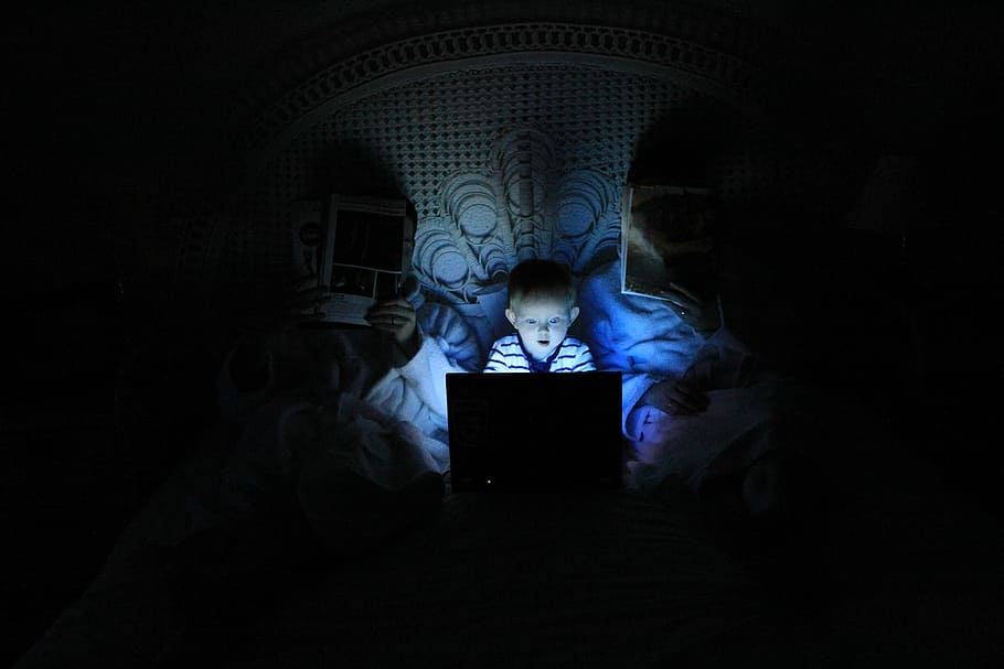 boy playing at laptop inside room, boy using laptop on bed near headboard HD wallpaper