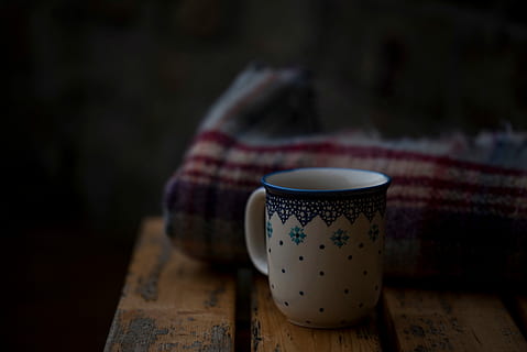 white and blue ceramic mug in front of beige and red textile HD wallpaper