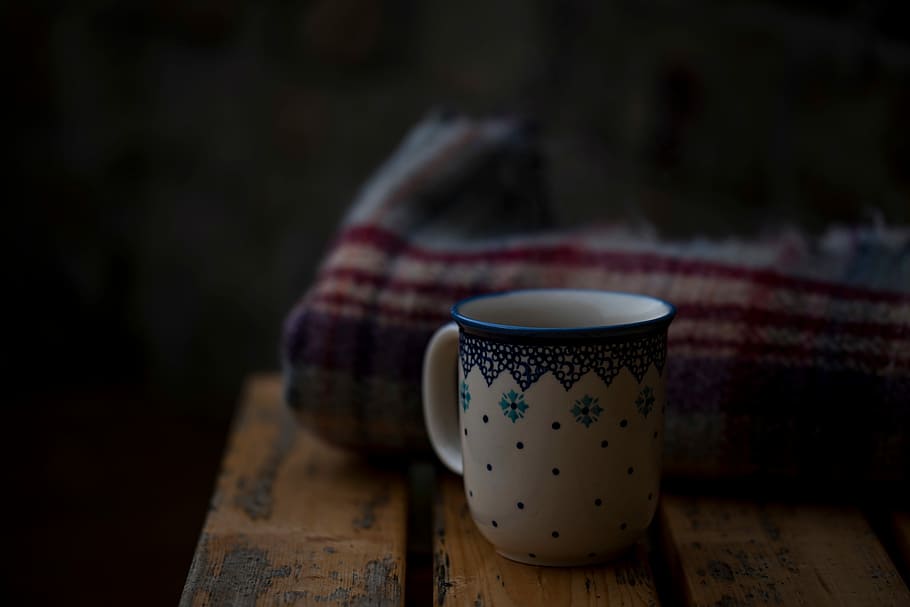 white and blue ceramic mug in front of beige and red textile HD wallpaper