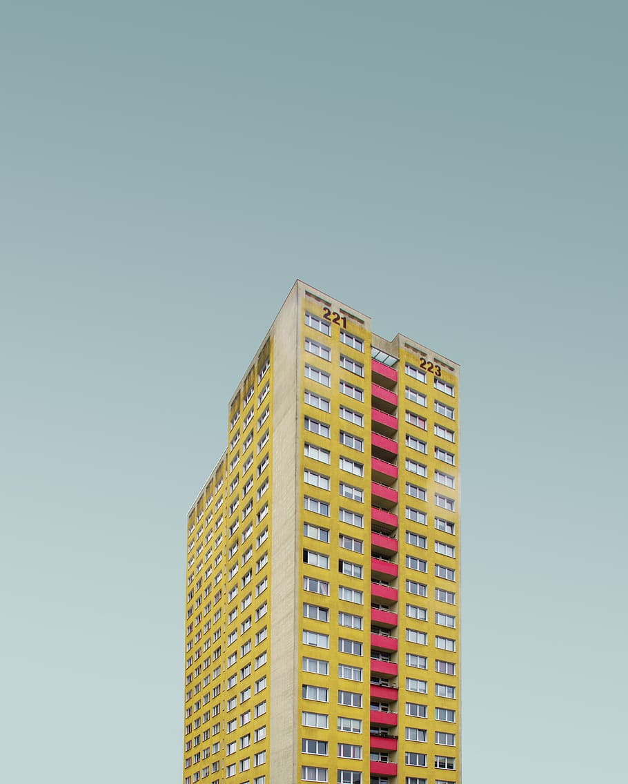 yellow and red high rise building, high rise building under clear sky HD wallpaper