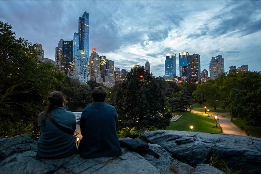 man and woman sitting on rock on Central Park, New York, couple