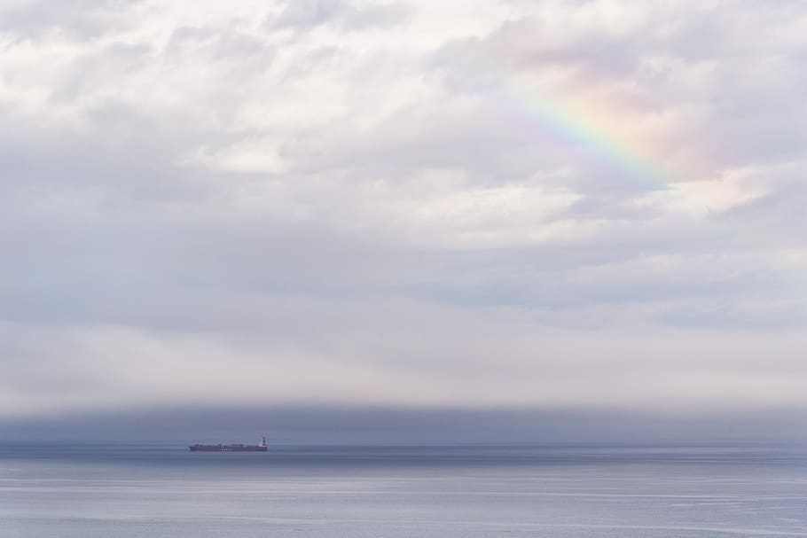vessel on ocean under cloudy sky with rainbow, body of water landscape HD wallpaper