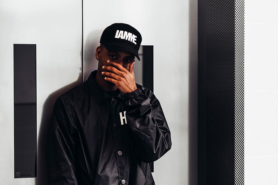 man covering his face in front of gray door, untitled, hand, hiding HD wallpaper