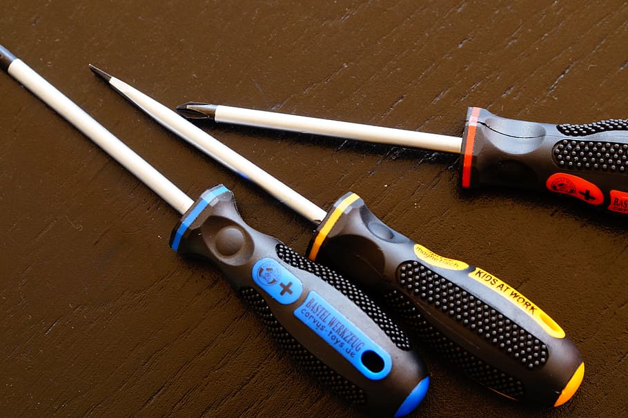 three assorted-color screw drivers on brown surface, Screwdriver