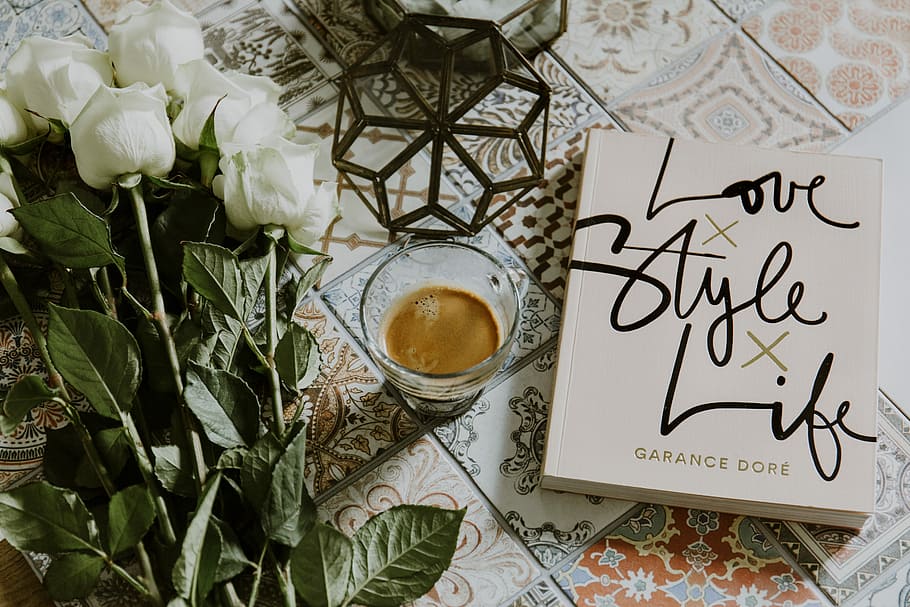 clear glass cup filled with coffee near white roses and book, white novel book beside drinking glass HD wallpaper