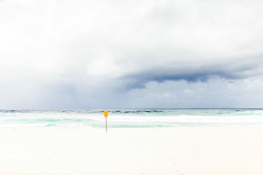 yellow pole on seashore under white clouds, shore near ocean under white clouds HD wallpaper