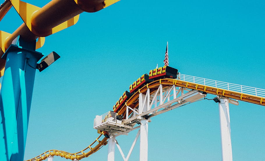 roller coaster on top of rail during daytime, architectural photography of train on rail HD wallpaper
