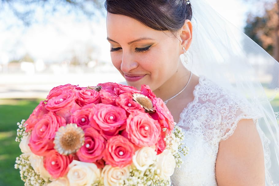 woman in wedding dress holding pink and white rose bouquet HD wallpaper