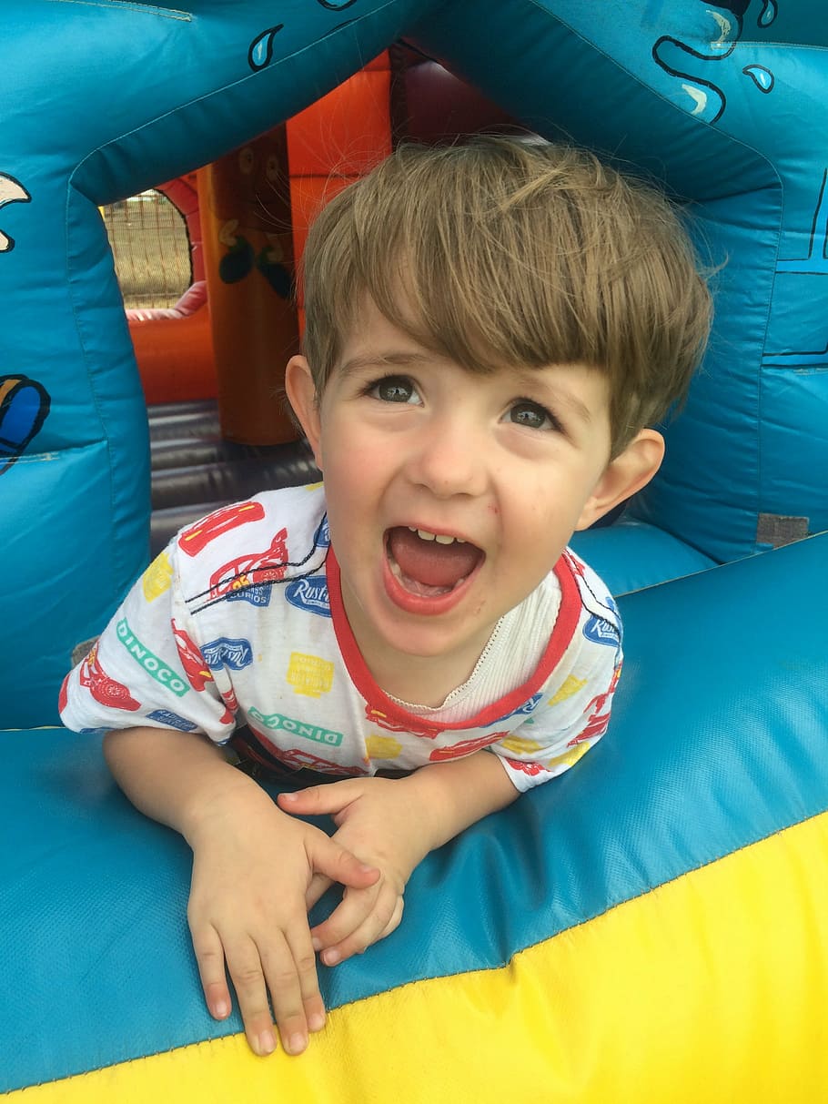 boy inside bounce house, jumping castle, child, childhood, fun