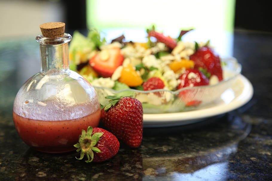 strawberries near glass bottle on black surface, food, dressing HD wallpaper