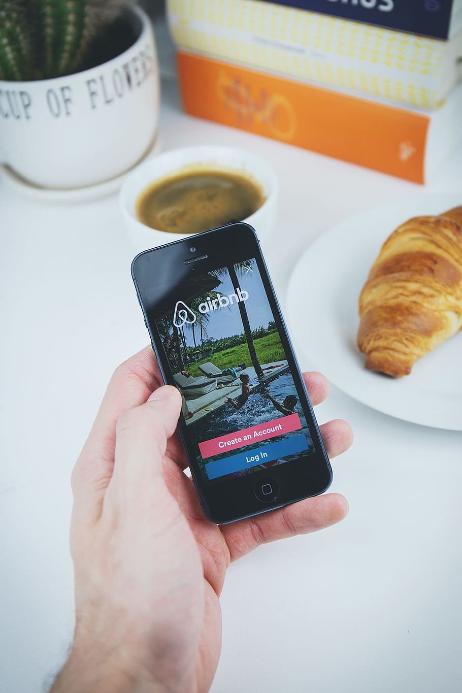 person using smartphone that displays lock screen, airbnb, app, HD wallpaper