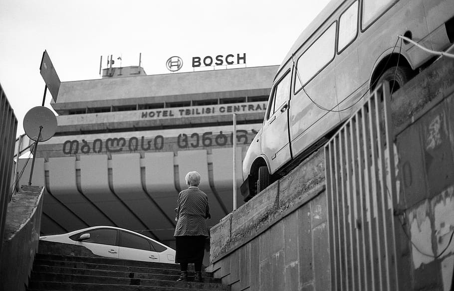 woman standing on stairs near Bosch building, woman looking at Bosch building