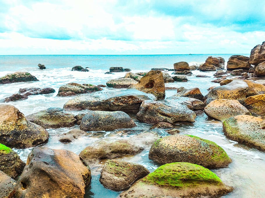 Landscape Photography of Rocks With Moss Surrounded by Body of Water HD wallpaper
