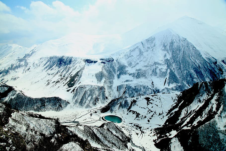 aerial view photography of snow-covered mountain under cloudy sky during daytime, aerial photo of Snow mountain HD wallpaper