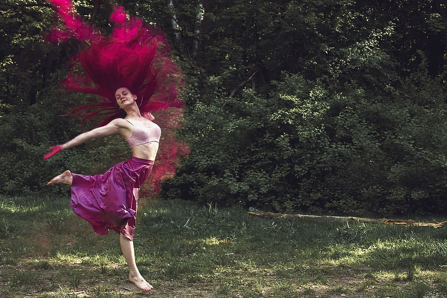 purple haired woman in pink sleeveless crop top jumping on green grass field HD wallpaper