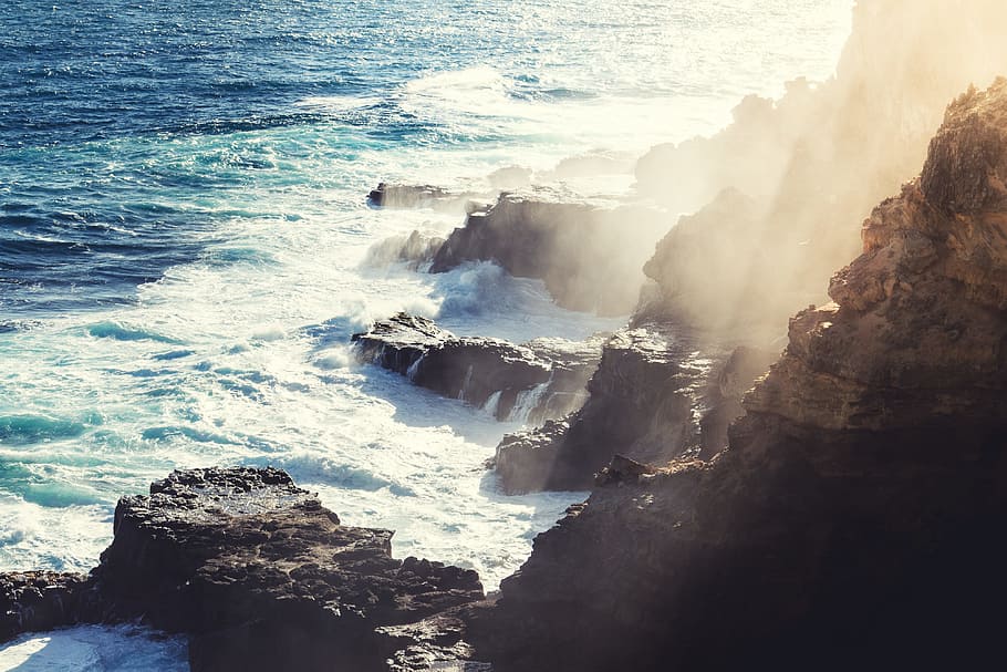 shallow focus photography of ocean, aerial view of rocky mountain over body of water HD wallpaper