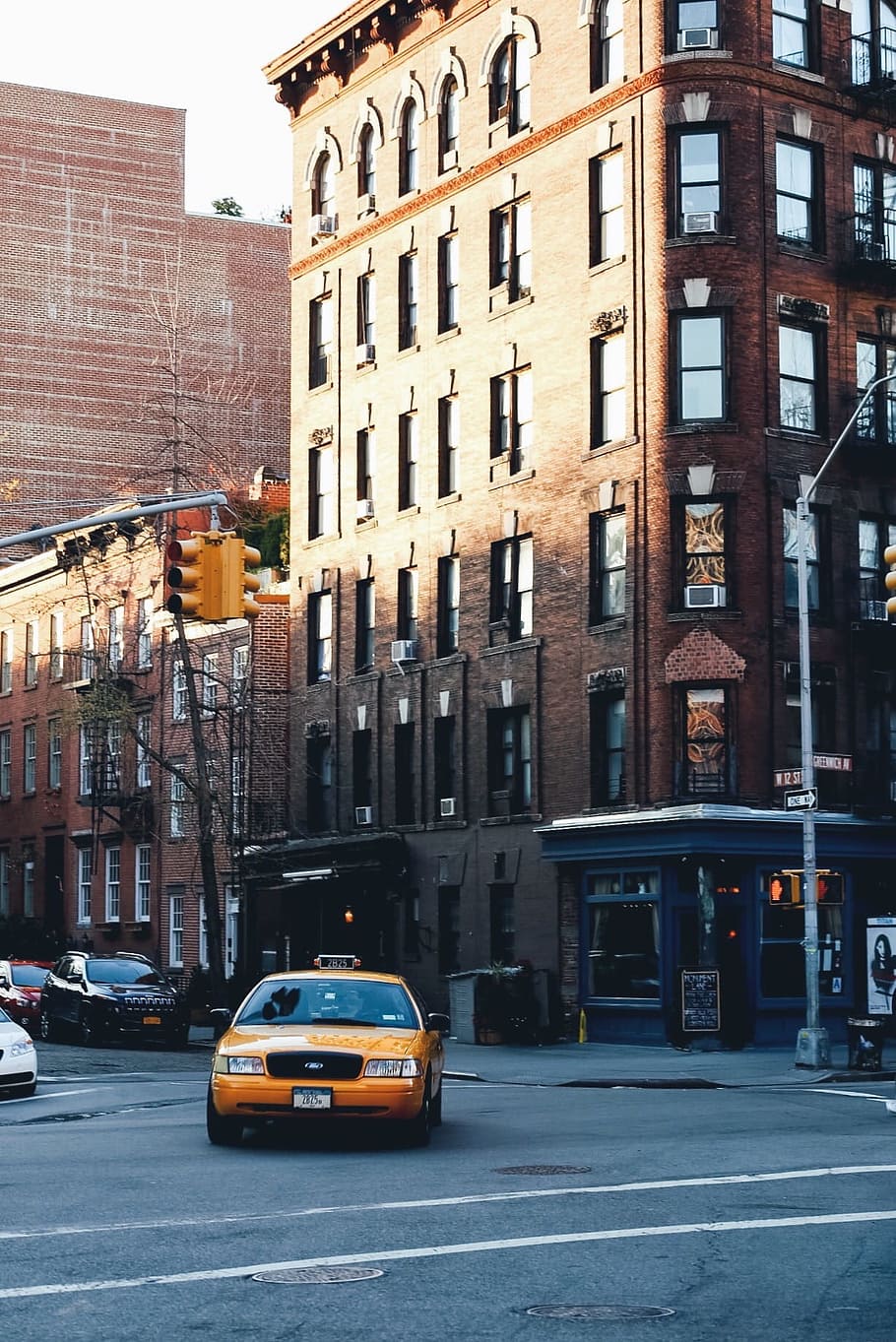 yellow taxi in front of brown brick building during daytime, brown concrete building, HD wallpaper