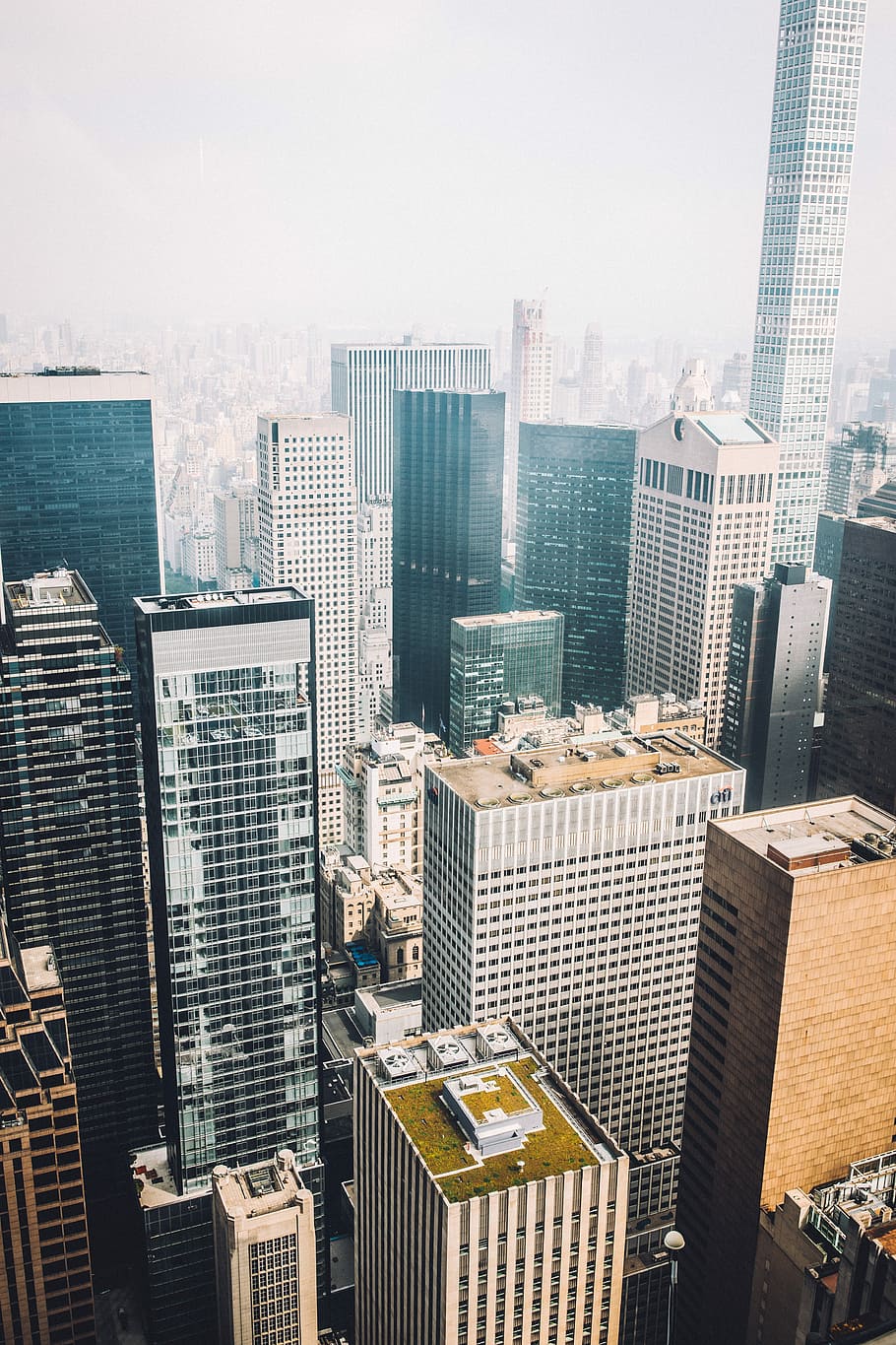 buildings in bird's-eye view photography, aerial photography of concrete high-rise buildings under cloudy sky HD wallpaper