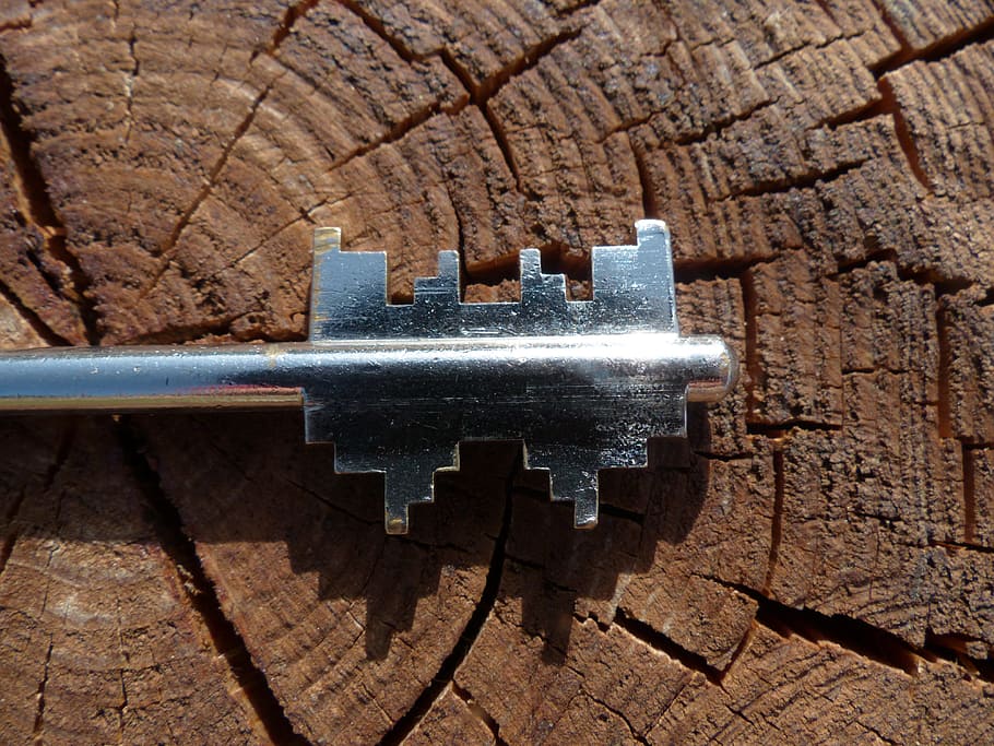 gray stainless steel key on brown wood, safe key, door key HD wallpaper