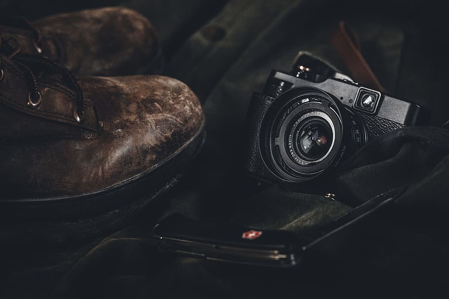 photo of a black point-and-shoot camera and pair of brown leather boots, black point-and-shoot camera and pair of brown work bots, HD wallpaper