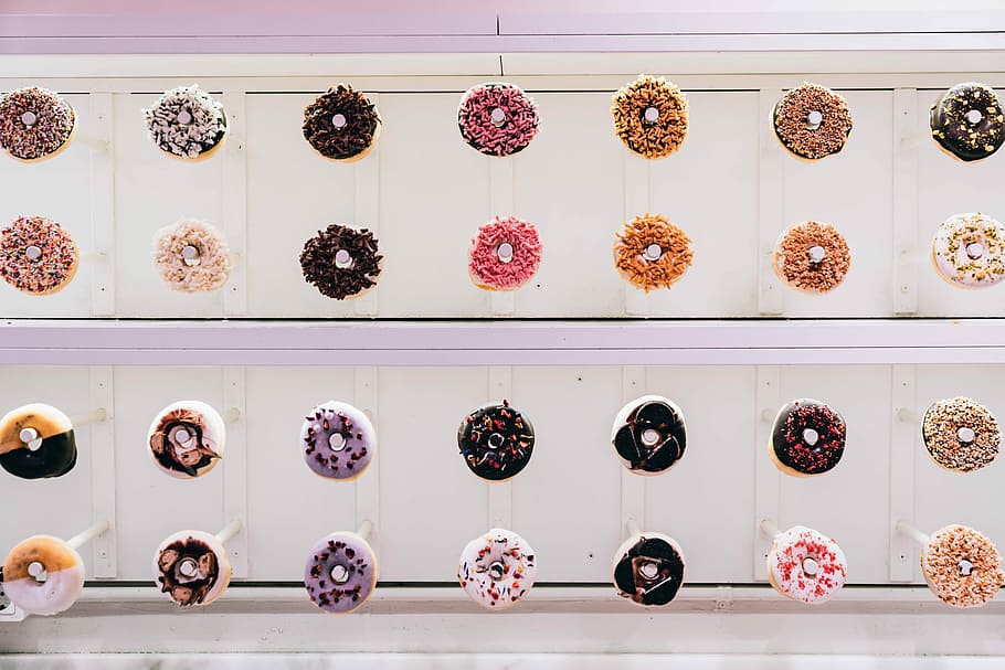 assorted-color sprinkled donut lot, flat-lay photography of doughnuts HD wallpaper