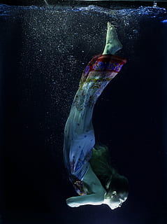 woman in white, red, and blue dress diving on water, tank, under water HD wallpaper