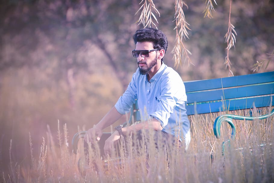 Indian male model posing for the photo while sitting on the land Stock  Photo | Adobe Stock