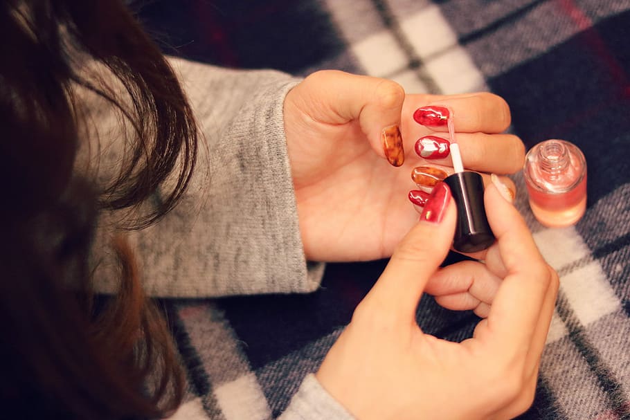 woman putting red nail polish, women, alcohol, people, human Hand HD wallpaper
