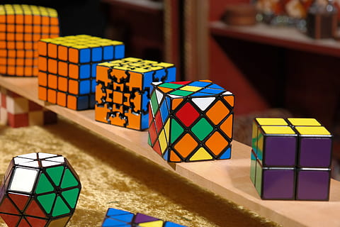rubik's cubes on brown surface, magic cube, patience games HD wallpaper