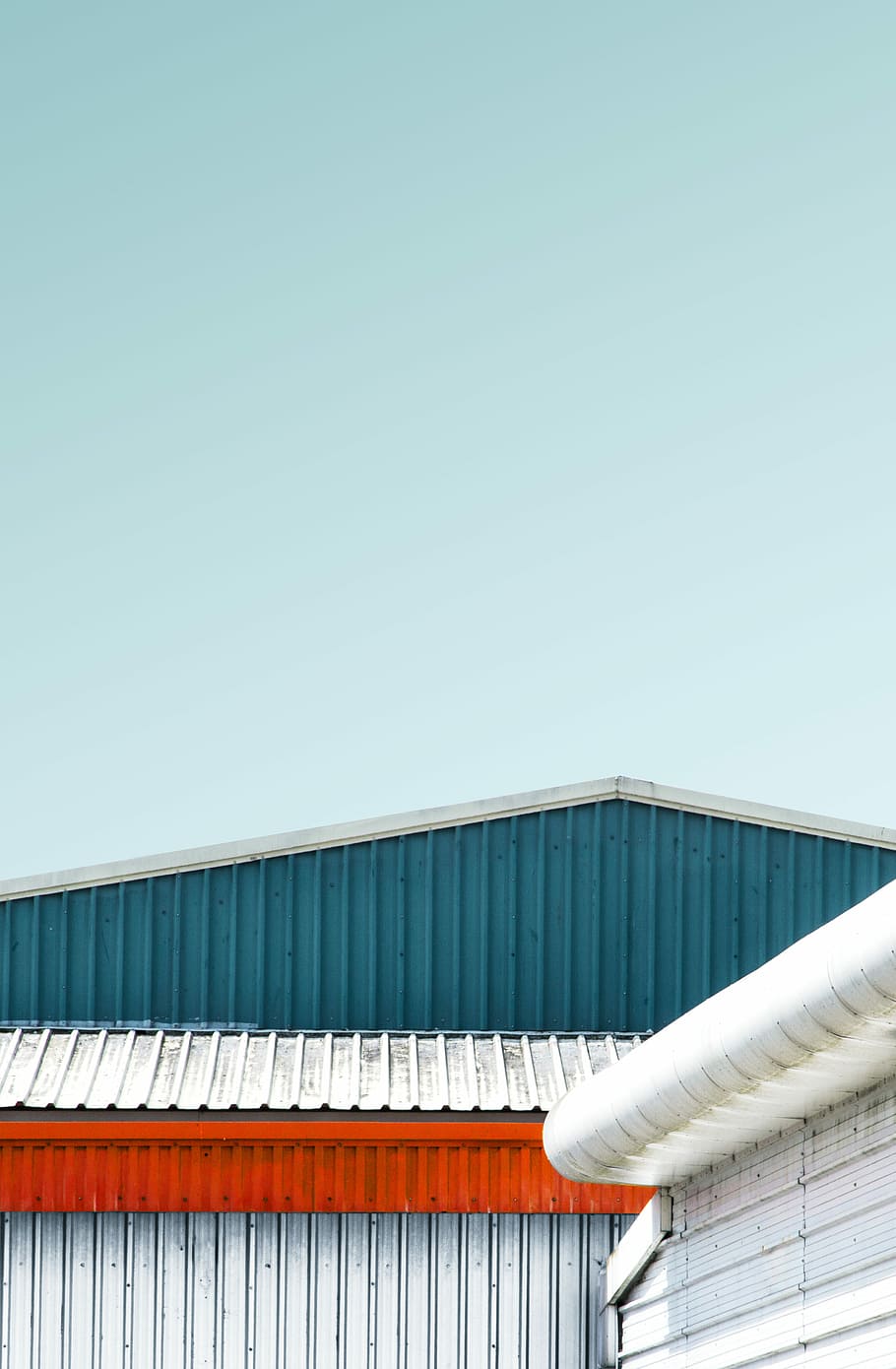 photo of gray and teal metal warehouse under clear sky, untitled HD wallpaper