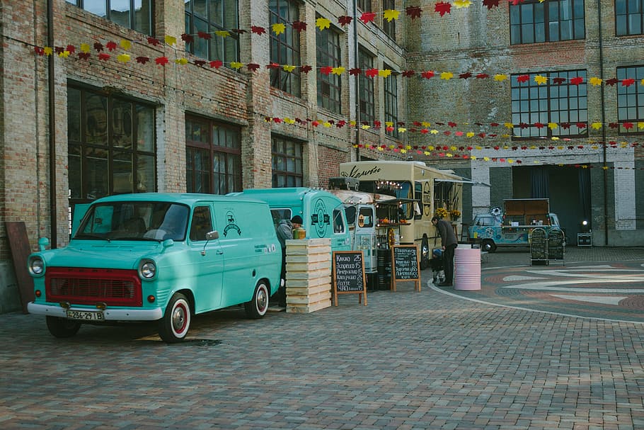 Green Minivan Near Brown Wooden Crate and Brown Food Truck, architecture