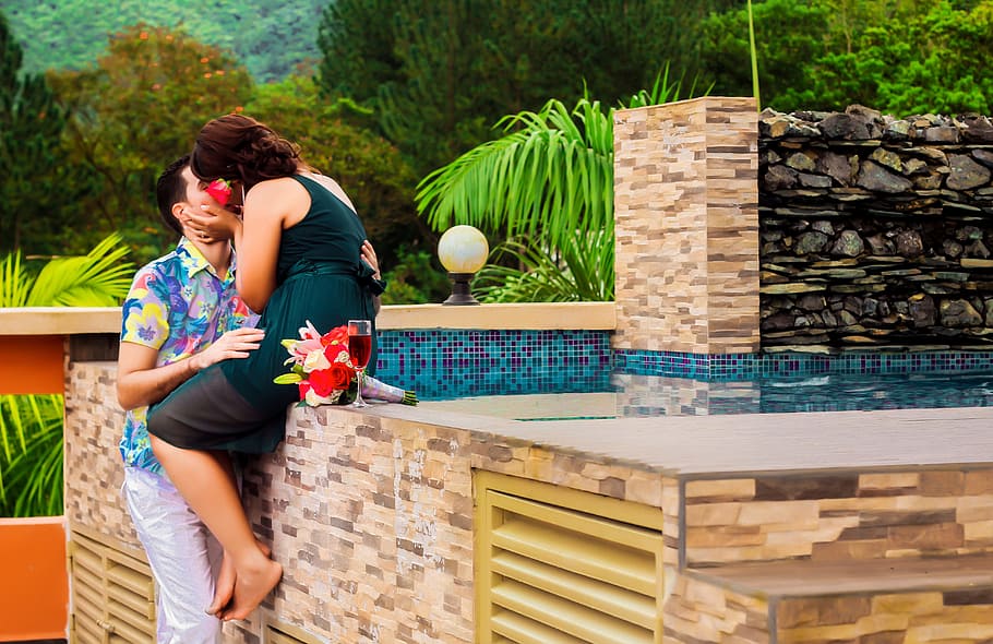 man and woman kissing beside the swimming pool, wedding, colonial zone