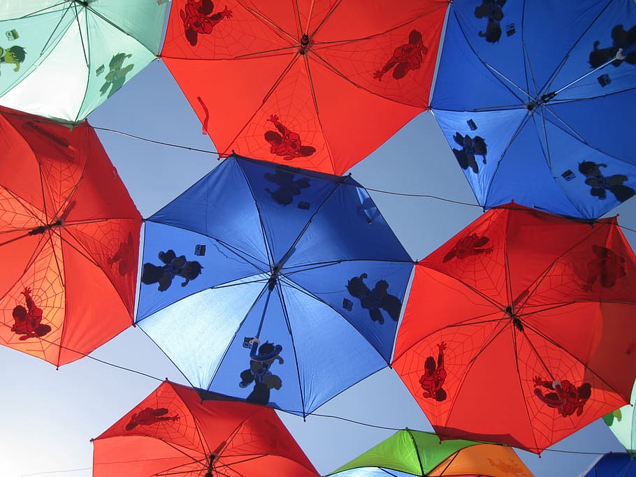 assorted-color umbrellas under the clear sky during daytime, red