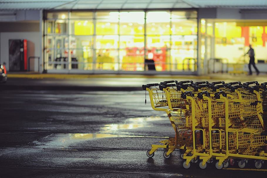 yellow shopping carts on concrete ground, shopping cart stacked in front of store