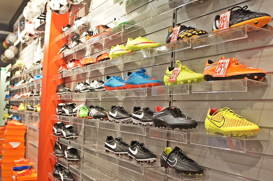 Nike shoe lot on white metal shelf, sports, shop, wall, football