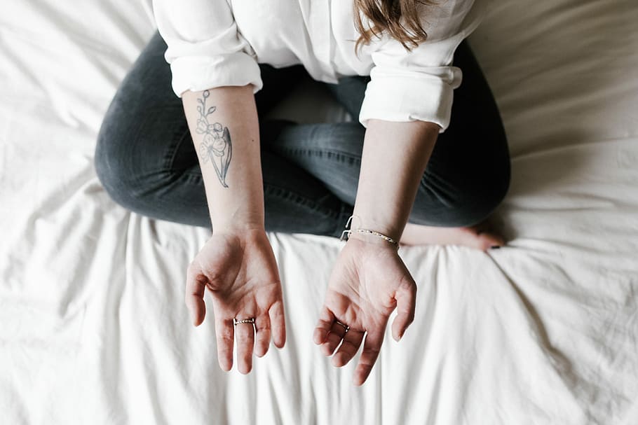 Tattoo, person in blue jeans, hand, bed, arm, woman, home, sitting HD wallpaper