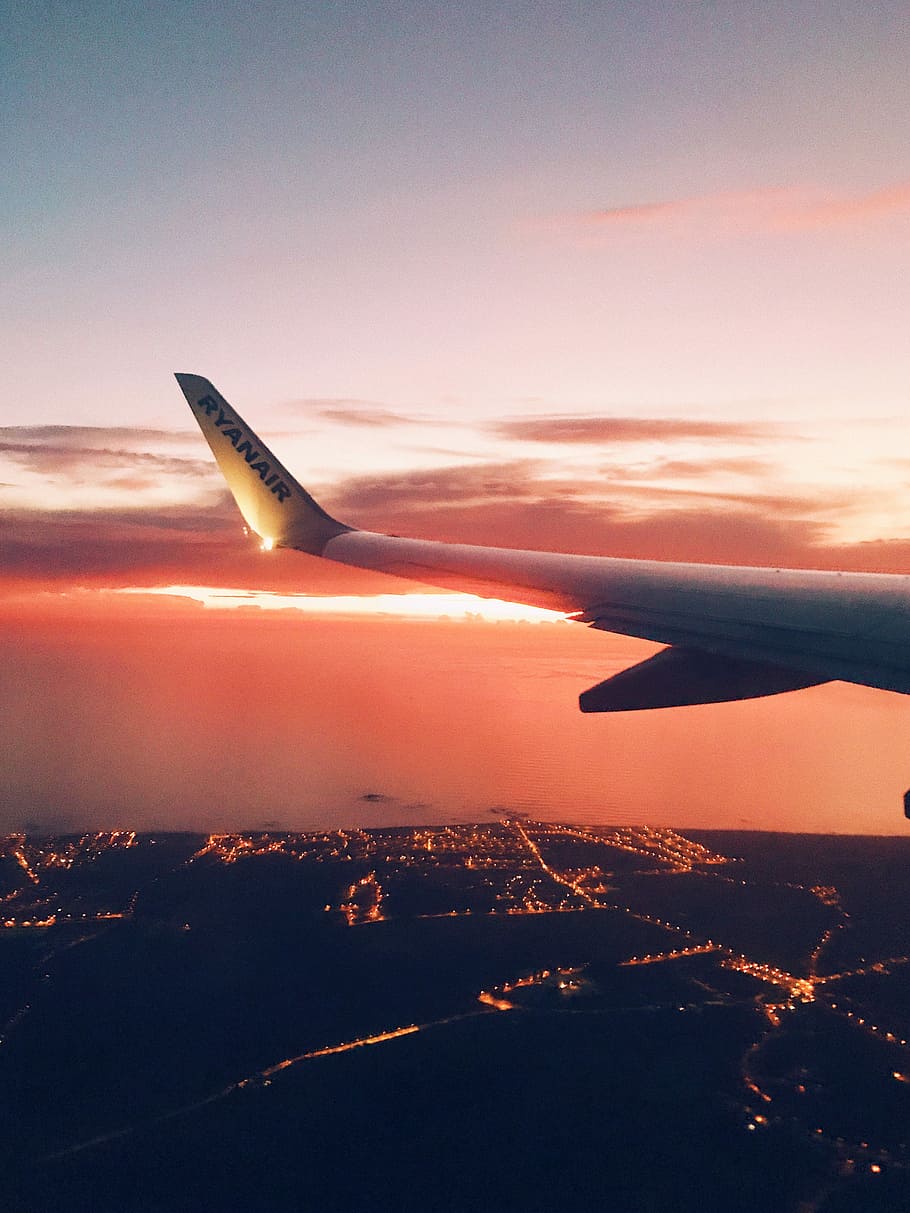 photo of airliner wing, white airplane tail during golden hour HD wallpaper