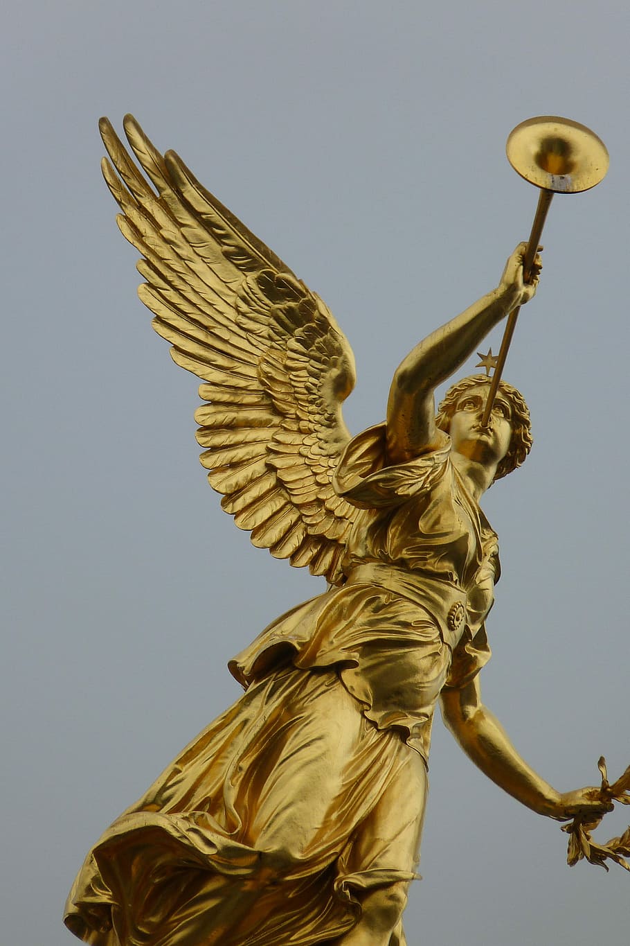 brass Angel with wind instrument statue, dresden, city, germany